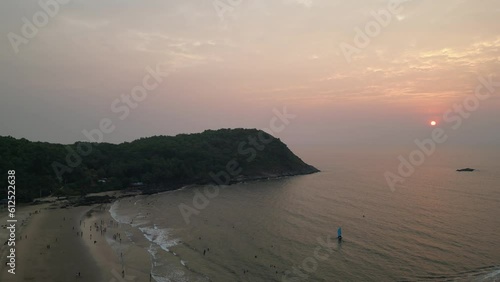 Aerial video of the rocky mountains covered with trees on the kudle beach, gokarna, karnataka, India photo