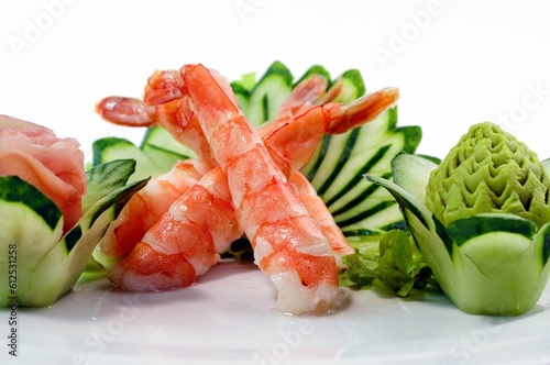 Closeup of prawns with decorated vegetables on a plate