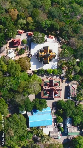 Aerial vertical video of Phnom Suntuk temples surrounded by trees, Cambodia photo