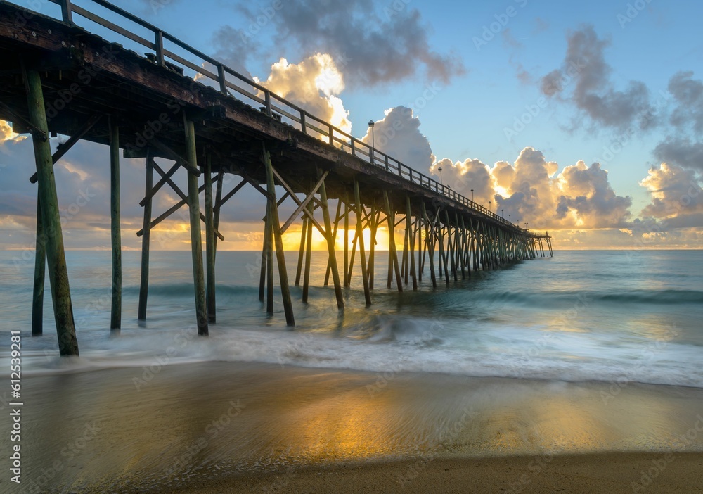 Scenic view of Carolina Beach pier during colorful sunrise, long exposure