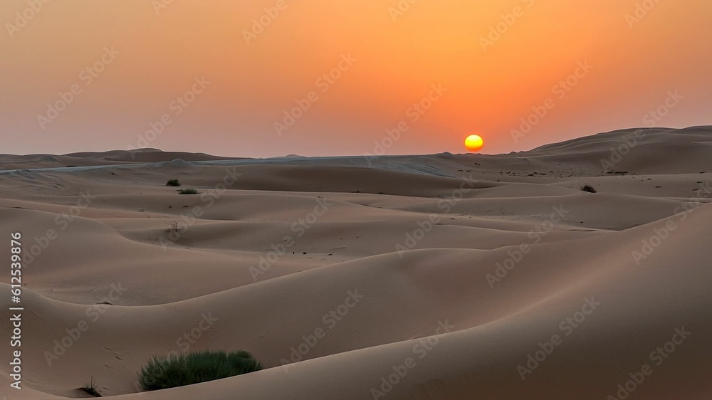 Beautiful scenery of an orange sunset over the desert