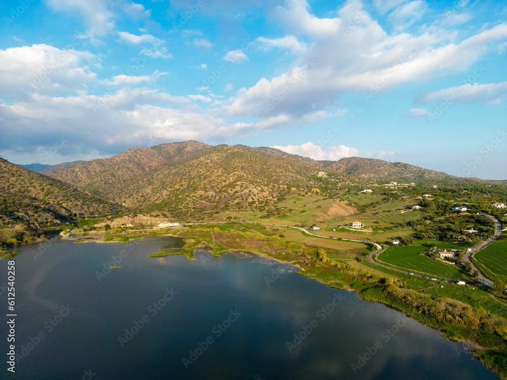 Beautiful view of a lake surrounded with green hills in Germasogeia Reservoir