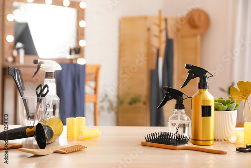 Different hairdressing tools on table in beauty salon