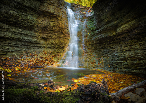 Fototapeta Naklejka Na Ścianę i Meble -  A small waterfall in rautal close to jena in thuringia at autumn
