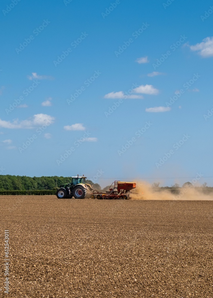Fototapeta premium Farmer at work ploughing his field