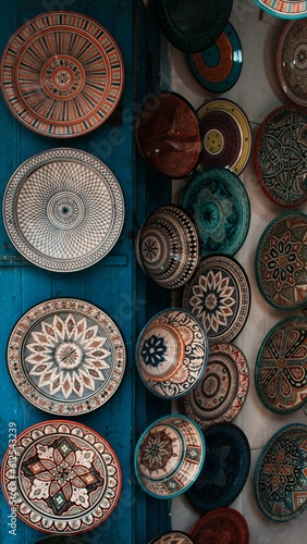 Vertical shot of Moroccan plates with national patterns demonstrated in a street market
