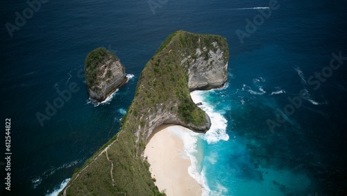 Top view of the Nusa Penida island with high rocky pieces in the middle of the blue sea, Bali