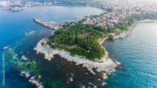 Aerial view of the coastline of an island with green vegetation
