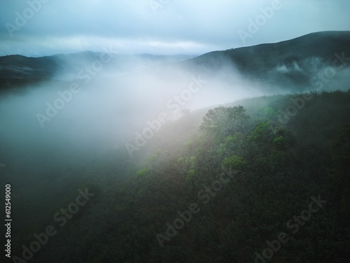 Scenic view of big layers of fog covering the Caldeirao mountain range in Algarve, Portugal photo