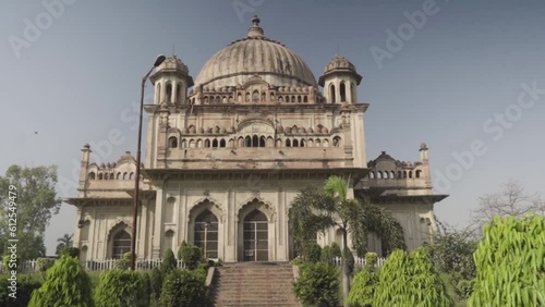 Tomb of Saadat Ali Khan in Lucknow City, India surrounded by lush green trees photo