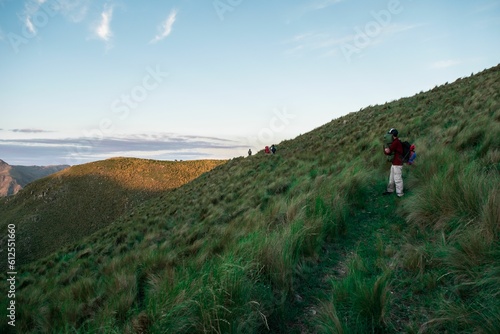 Person hiking on the hill at sunset