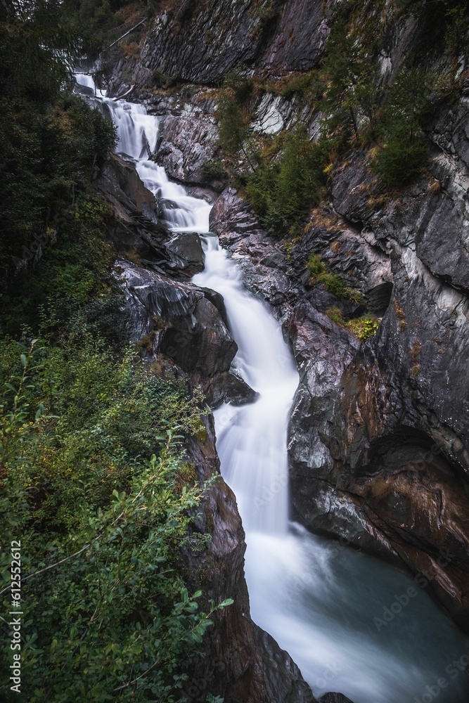 Vertical long exposure shot of the Umbal Falls, Tyrol, Austria