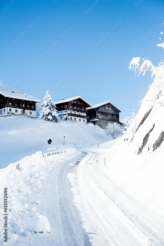 Aerial view of snow covered mountain landscape with buildings