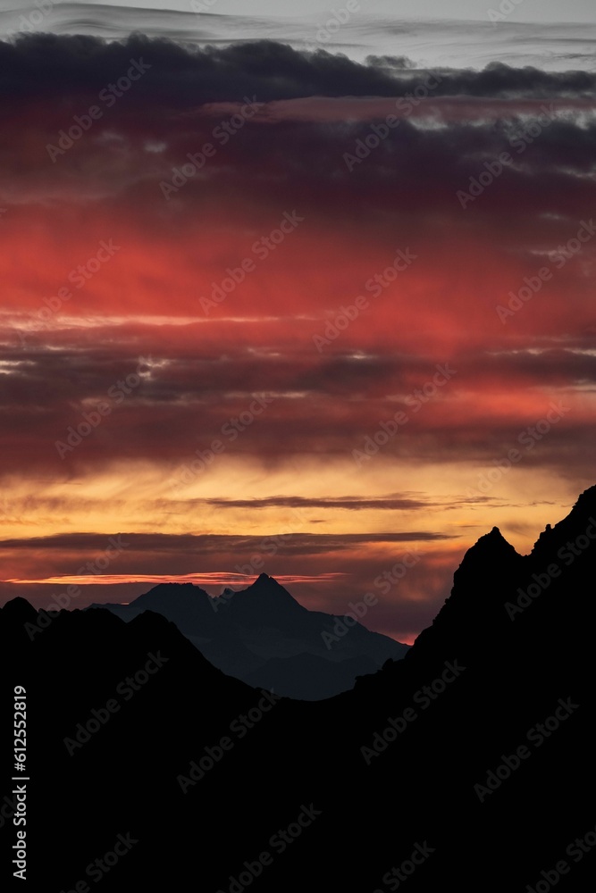 Silhouette mountains under colorful sky during sunset