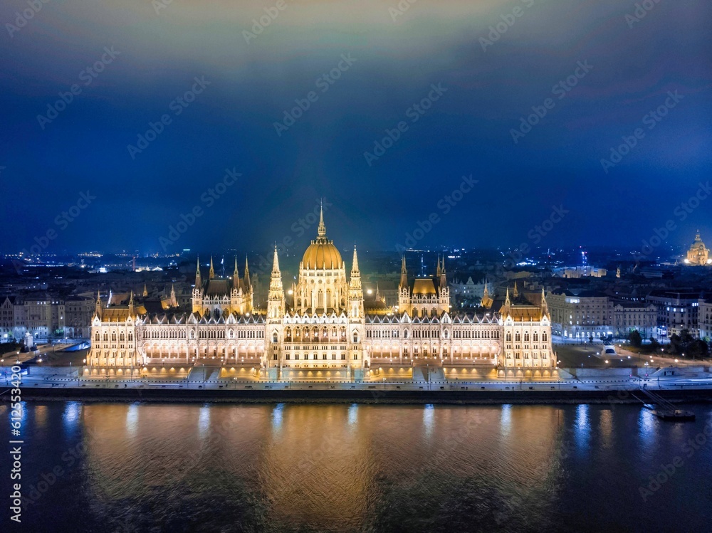 Beautiful night view of the main facade of the Parliament of Budapest covered with lights