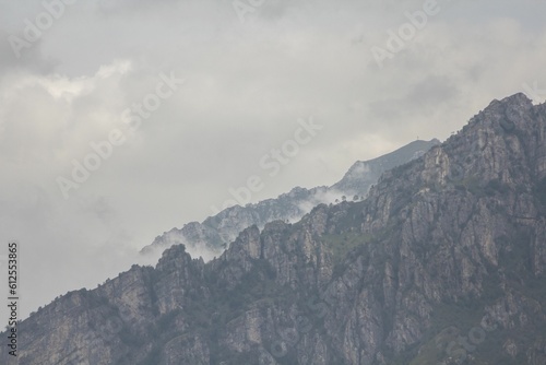 Aerial view of mountain landscape surrounded by clouds