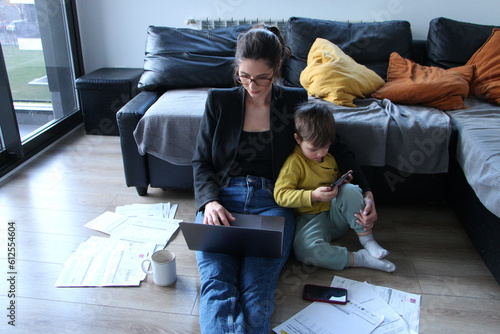 Mom working on a laptop holding her boy