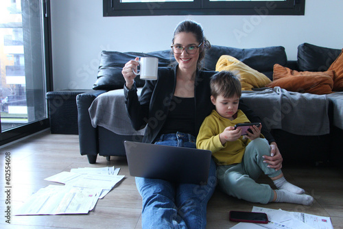 Modern mother working with her baby besides her