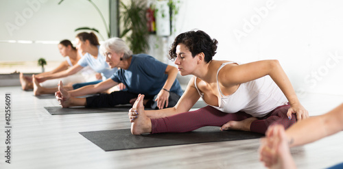 Group of different aged women stretching in gym