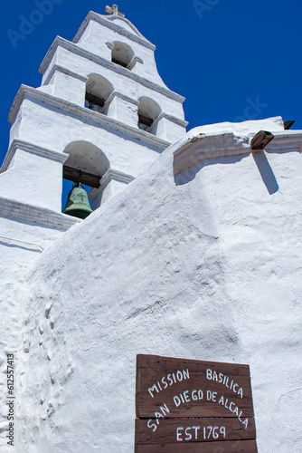 Wooden Sign Greets Visitors to the Brilliant White Adobe Buildings of the Mission Basilica San Diego de Alcala in San Diego, California, USA