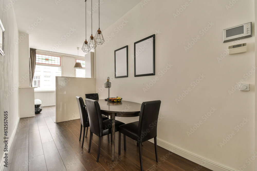 Fototapeta premium a dining room with a table and chairs and a