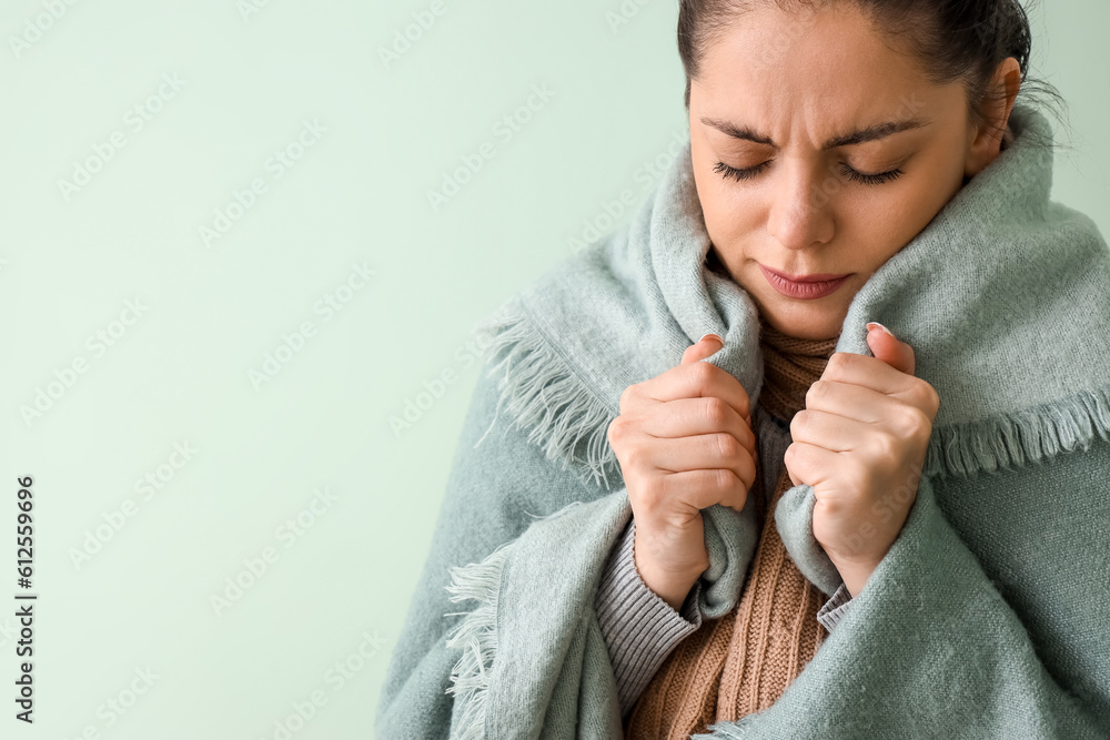 Ill young woman in plaid on green background, closeup Ill young woman in plaid on green background, closeup