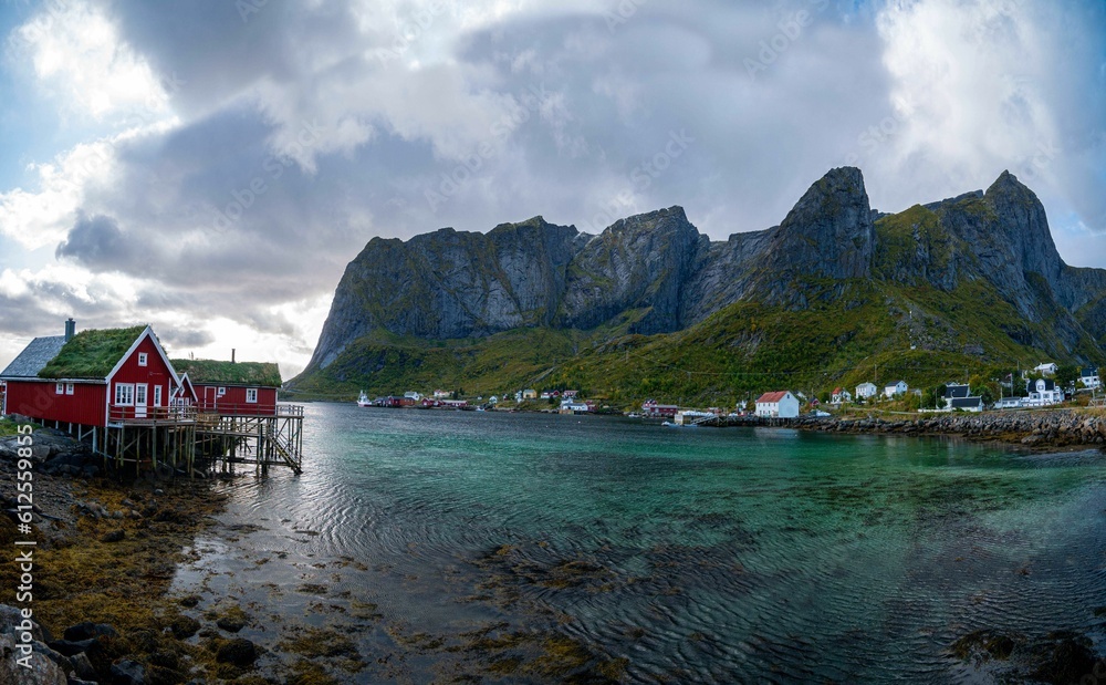 Naklejka premium Scenic view of Lofoten Islands with residential buildings under the cloudy sky, Norway