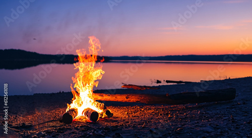 beautiful campfire in the middle of the beach at sunset photo