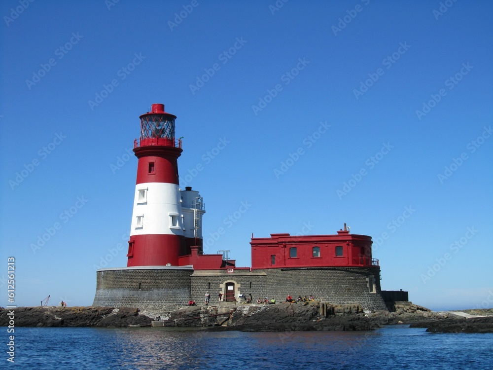 Longstone lighthouse with a blue sky in the background, in England, United Kingdom