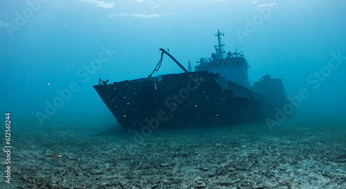 destroyed ship under the deep sea on the dirty sand