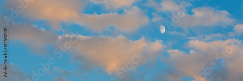 Beautiful sunset sky background with clouds. Scenic cloudscape. Wide panoramic background for design.