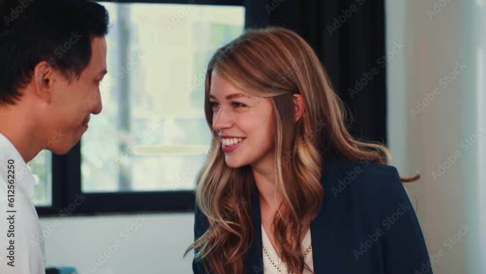Young attractive female manager hake hands celebrating agreement with male business partner Young attractive female manager hake hands celebrating agreement with male business partner