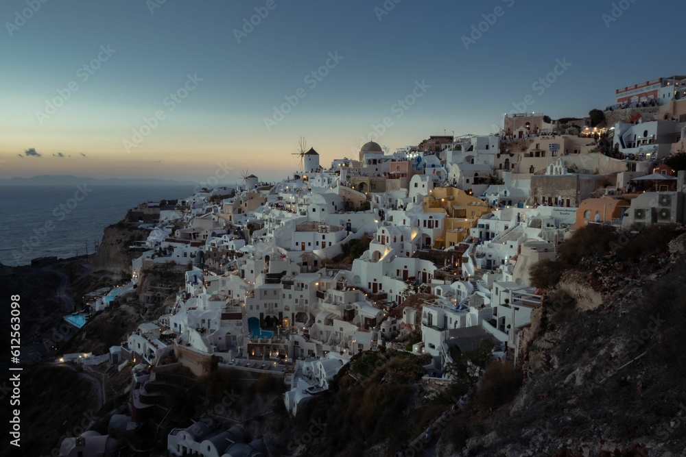 Aerial view of Santorini island surrounded by buildings during sunset