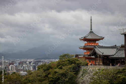 Buddhist temple  Kiyomizu-dera in Kyoto  Japan  surrounded by green trees on a cloudy day