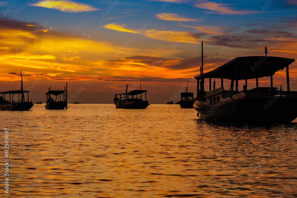 Beautiful sunset over the sea with boats near Belitung Island, Indonesia.