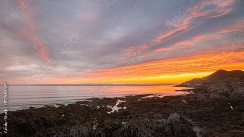 Horizontal view of the Woolacombe beach and surrounding nature under the beautiful sunset in July