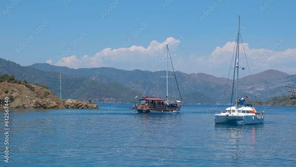 Ship voyage in spectacular sea. Some ships moving slowly in the turquoise sea with tourists in summer. Ship voyage in spectacular sea. Some ships moving slowly in the turquoise sea with tourists in summer.