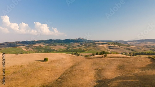 Aerial view of the Tuscany fields located in Italy seen on a beautiful sunny day © Epic Life Flashes/Wirestock Creators