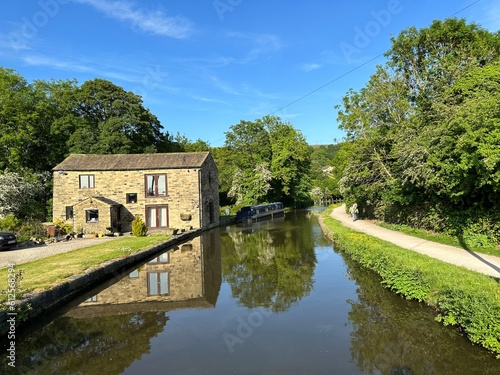 View of the, Leeds to Liverpool canal, with an old house, and a narrow boat,  near, Morton Lane, Bingley, UK © derek oldfield