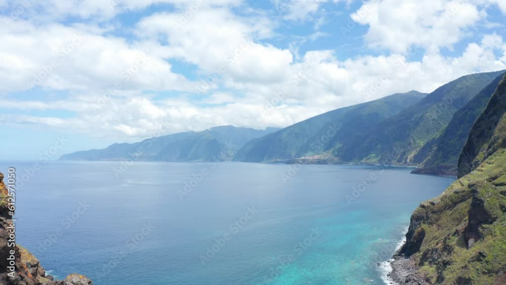 Aerial view of the scenic shore of Madeira Island under a sunny sky Aerial view of the scenic shore of Madeira Island under a sunny sky