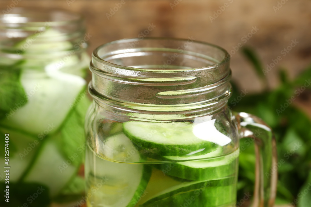 Mason jars of infused water with cucumber slices, closeup Mason jars of infused water with cucumber slices, closeup