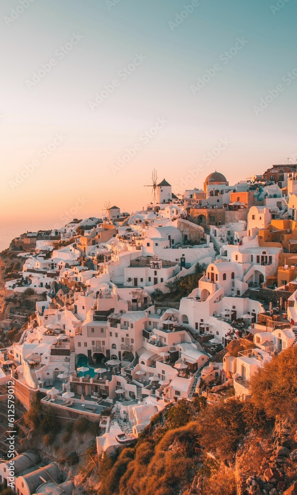 Cityscape of Santorini with old windmills and white buildings
