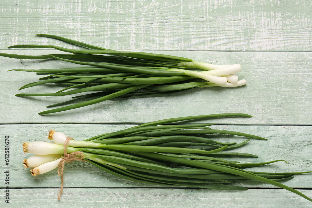Fresh green onion on wooden background Fresh green onion on wooden background