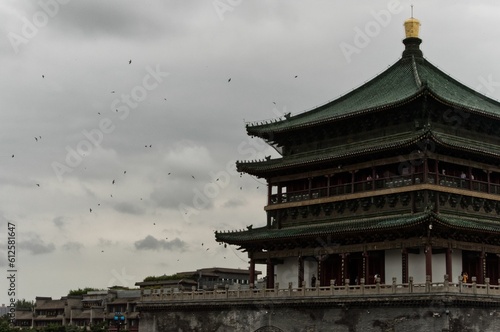 Bunch of wallow Flying Xi'an Bell Tower, Shaanxi, China under a cloudy sky