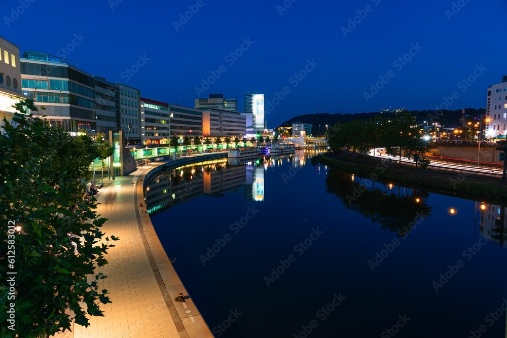 Cityscape of Saarbrucken at night with a river and reflections Cityscape of Saarbrucken at night with a river and reflections