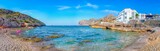 Coastal landscape with tourist resting on the beach Cala Sant Vicenc in Mallorca