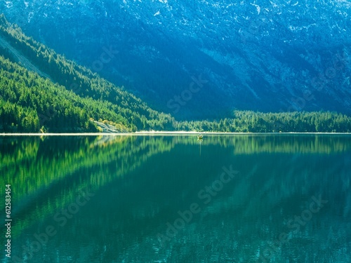 Image of a mountain's reflection on the water full of green nature.