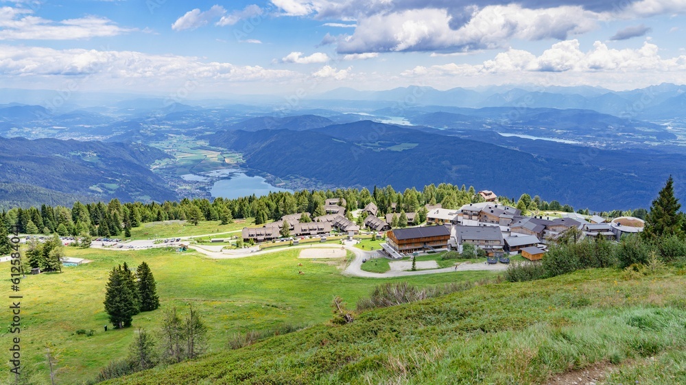 View over the resort in Gerlitzen Alp in Austria with mountains and a lake in the sunny background