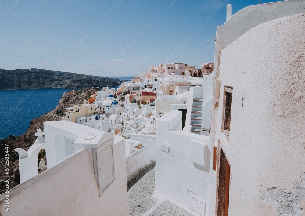 Beautiful white buildings at the coast in Thera, Santorini on a sunny day
