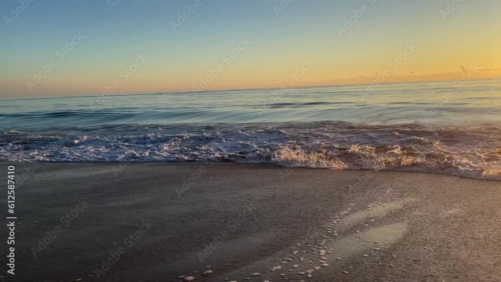 Breathtaking view of the waves hitting the sand beach Breathtaking view of the waves hitting the sand beach